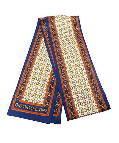 Navy, cream and rust colored twilly scarf with a gold horsebit pattern 