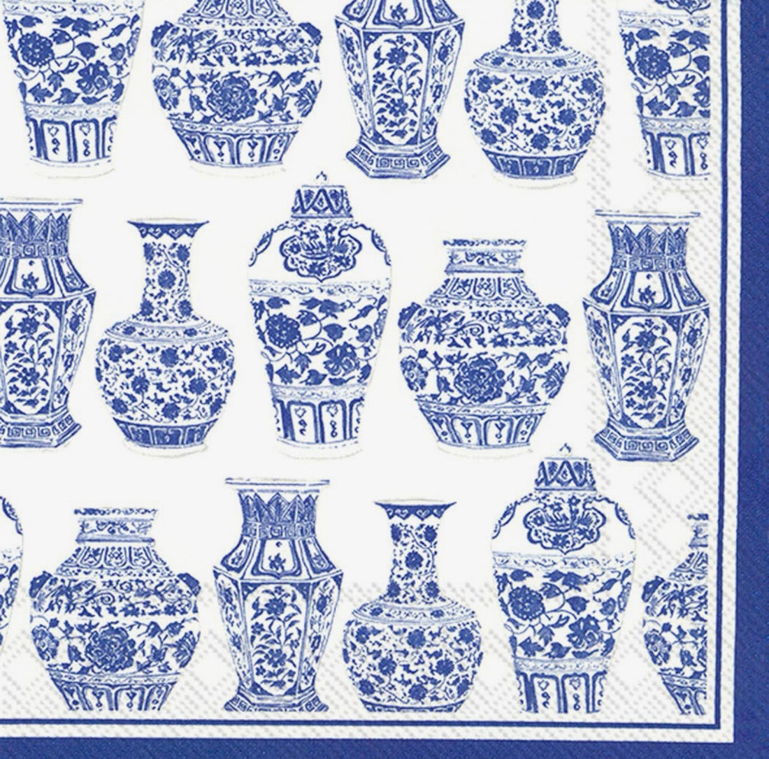 Blue-and-white patterned paper napkins featuring a repeating design of classical Chinese-style ceramic vases and lotus motifs.