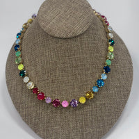 Multicolored beaded necklace on a brown fabric display