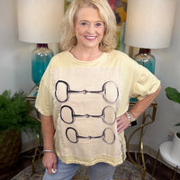 Cream colored oversized t-shirt with lined graphic applique with horsebit pattern