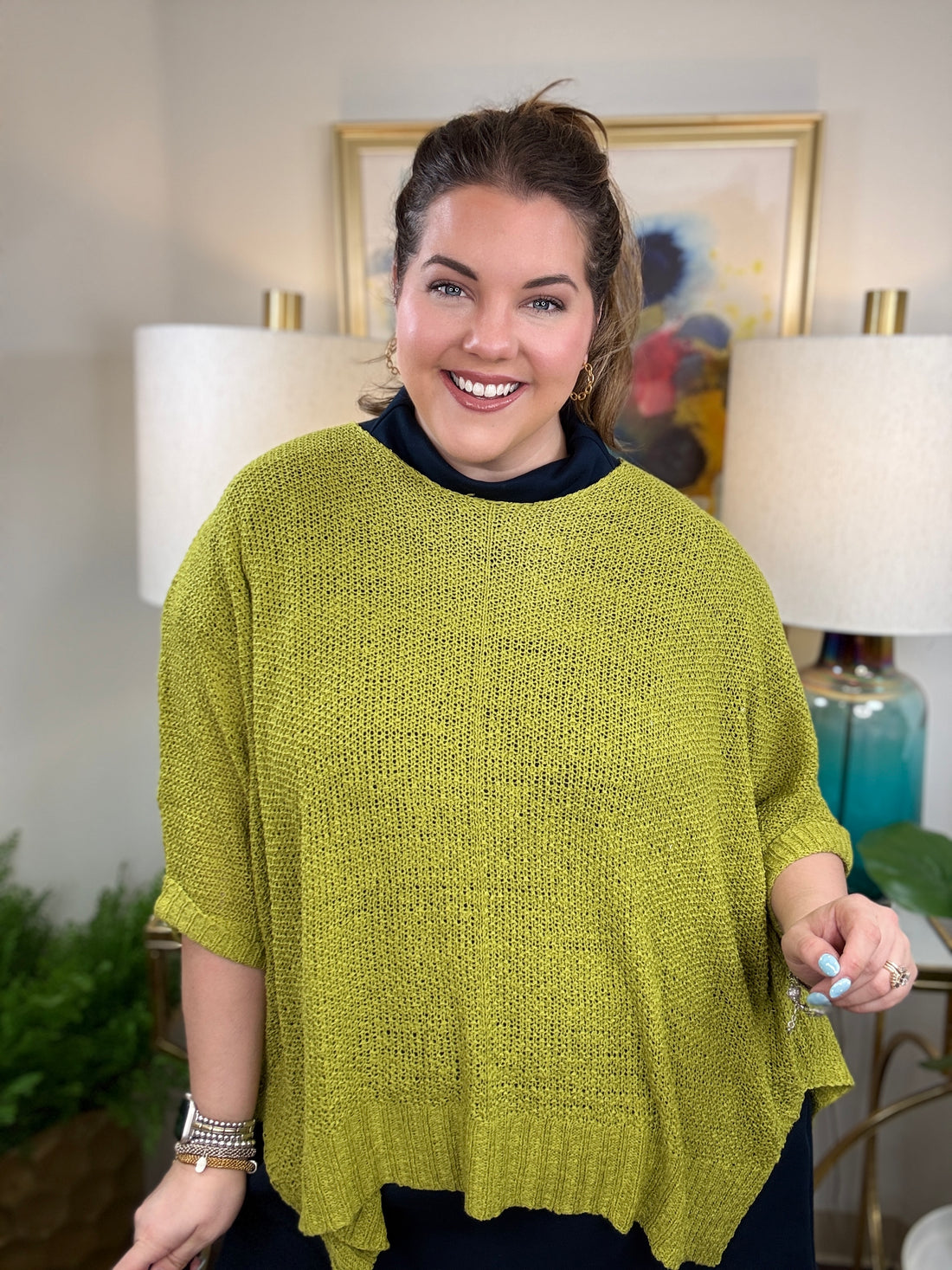 Woman wearing a short sleeved chartreuse sweater.