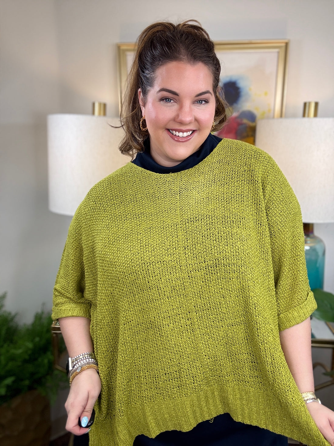 Woman wearing a short sleeved chartreuse sweater.