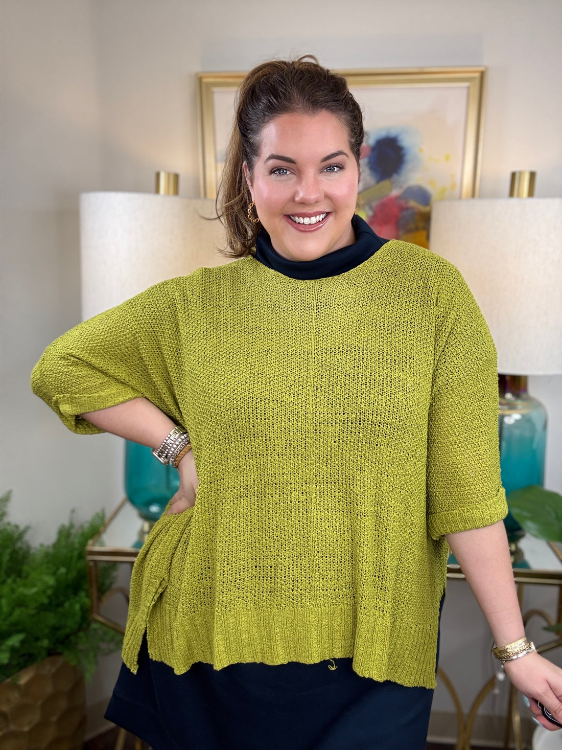 Woman wearing a short sleeved chartreuse sweater.