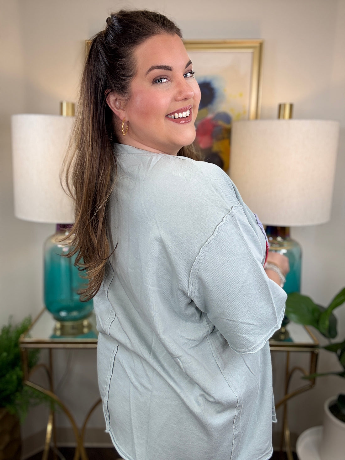Woman wearing a dusty blue american flag shirt.