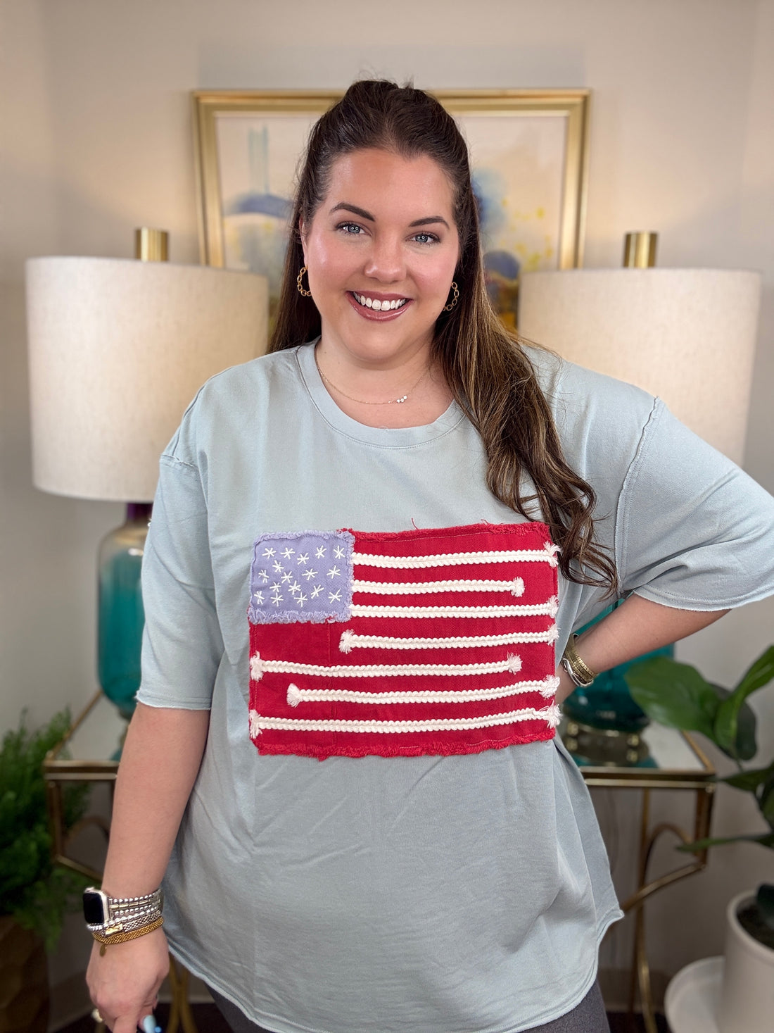 Woman wearing a dusty blue American flag shirt.