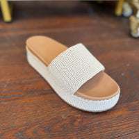 Beige sandal with brown sole