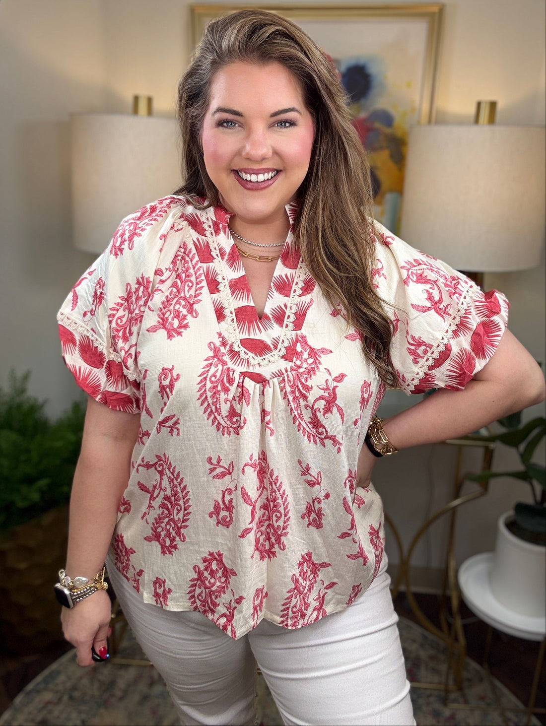 Woman wearing a red and white patterned blouse 