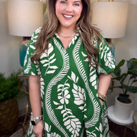 Woman wearing a green and white patterned dress