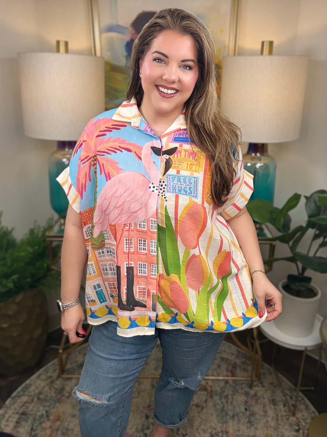  Woman wearing a top with whimsical flamingo print with tropical details.