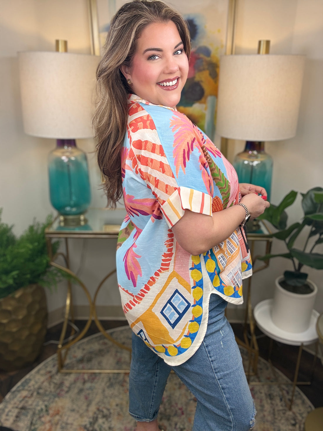  Woman wearing a top with whimsical flamingo print with tropical details