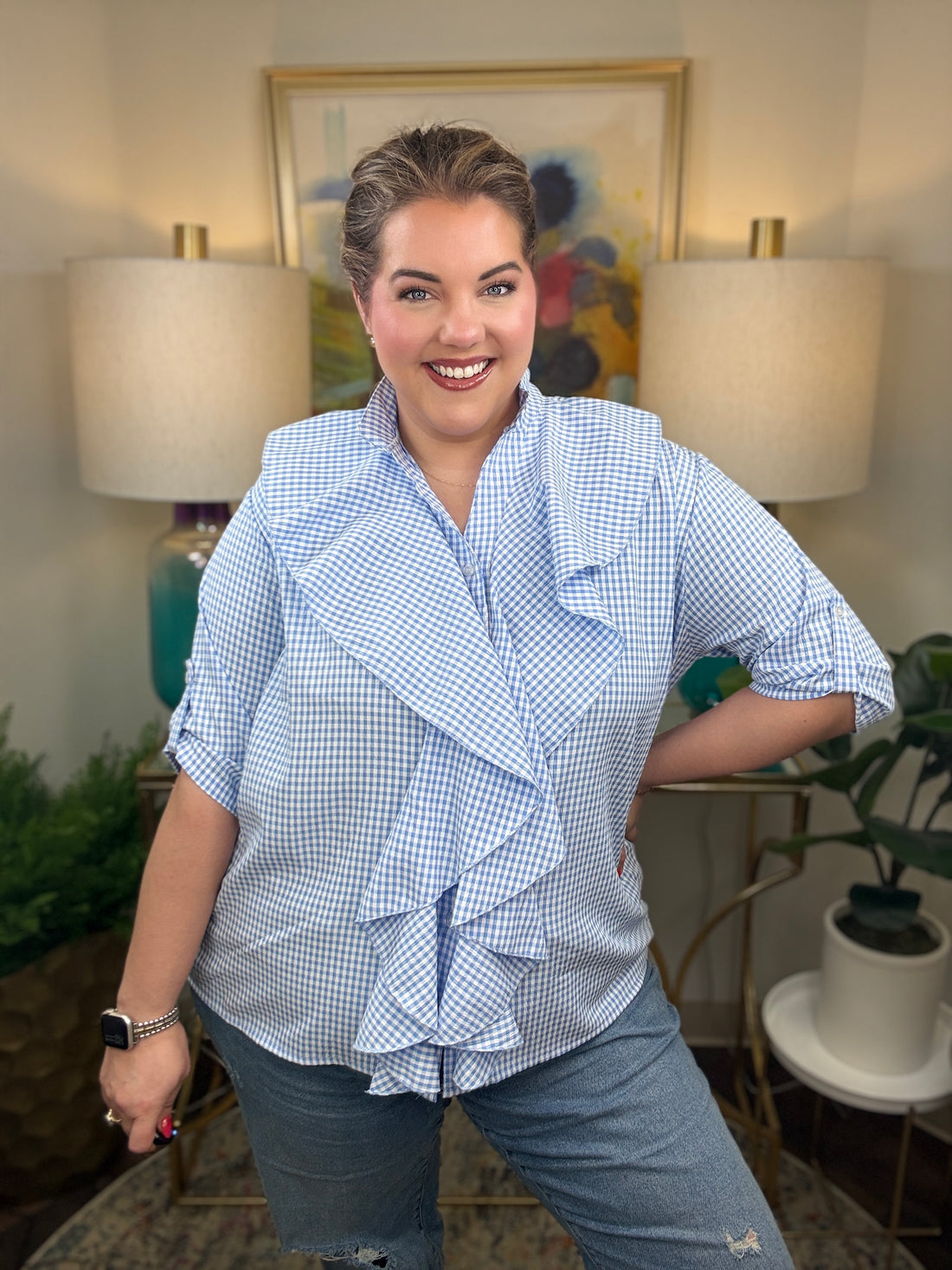 Woman wearing a blue checkered blouse with ruffles