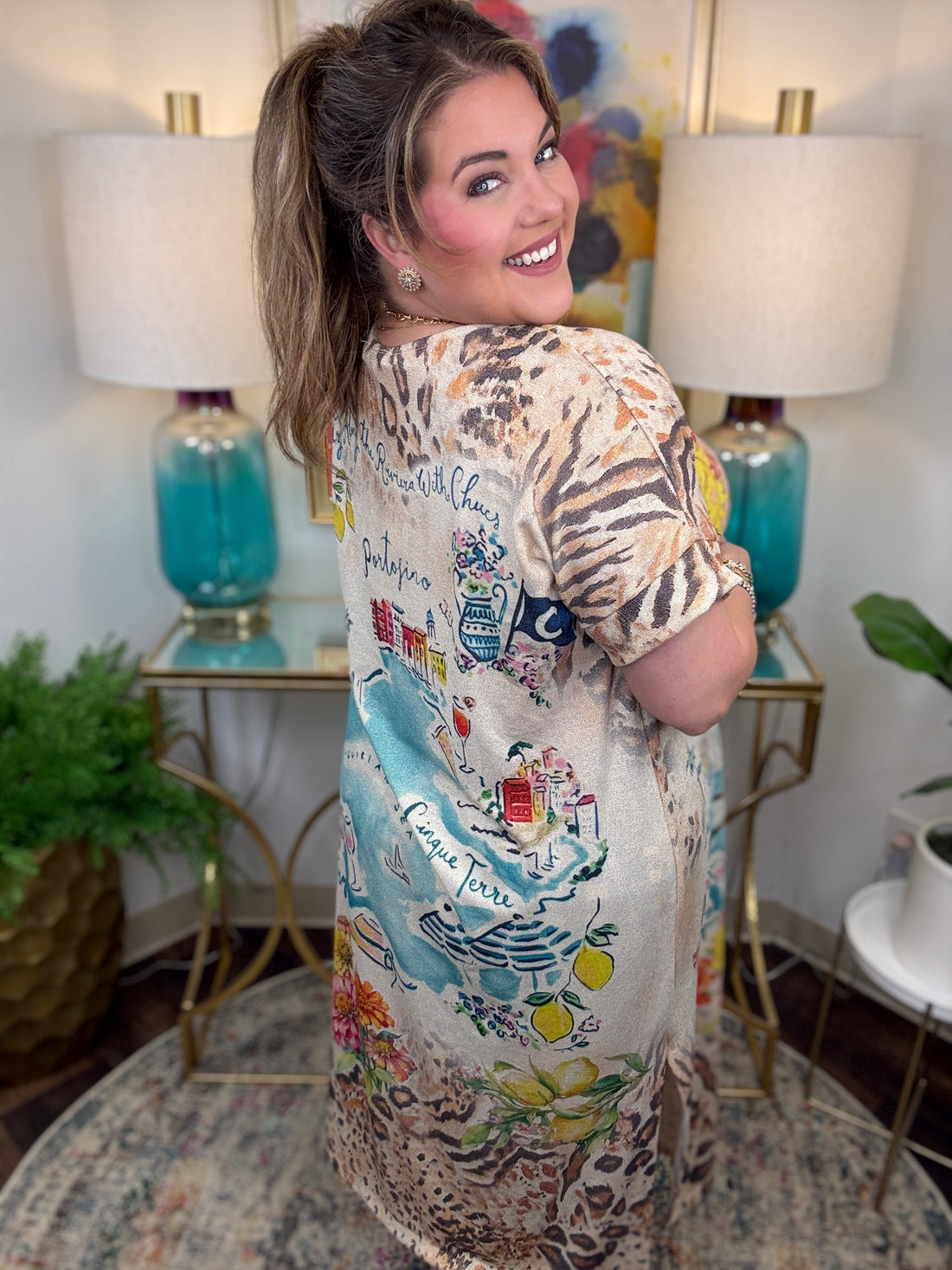 Woman wearing a patterned dress in a room with lamps and decor