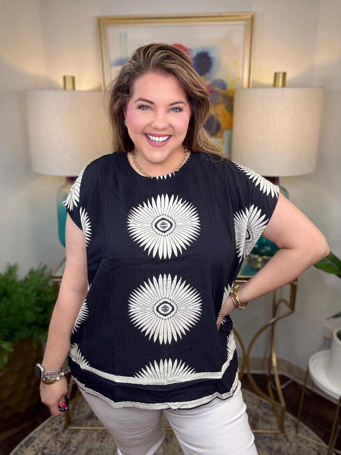 Woman wearing a black top with white starburst design