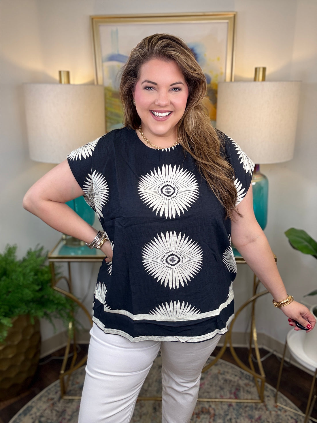 Woman wearing a black top with white starburst design