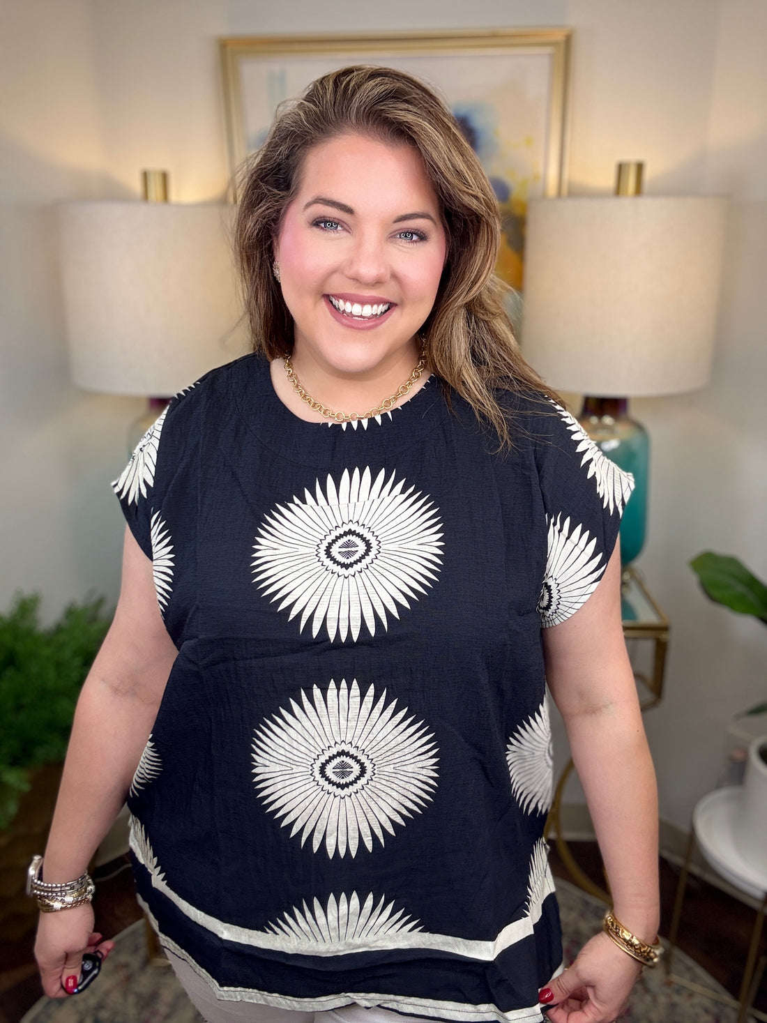 Woman wearing a black top with white starburst design