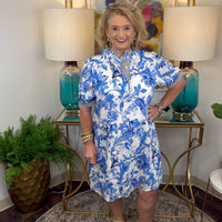 Woman in a blue and white floral dress