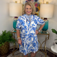 Woman in a blue and white floral dress