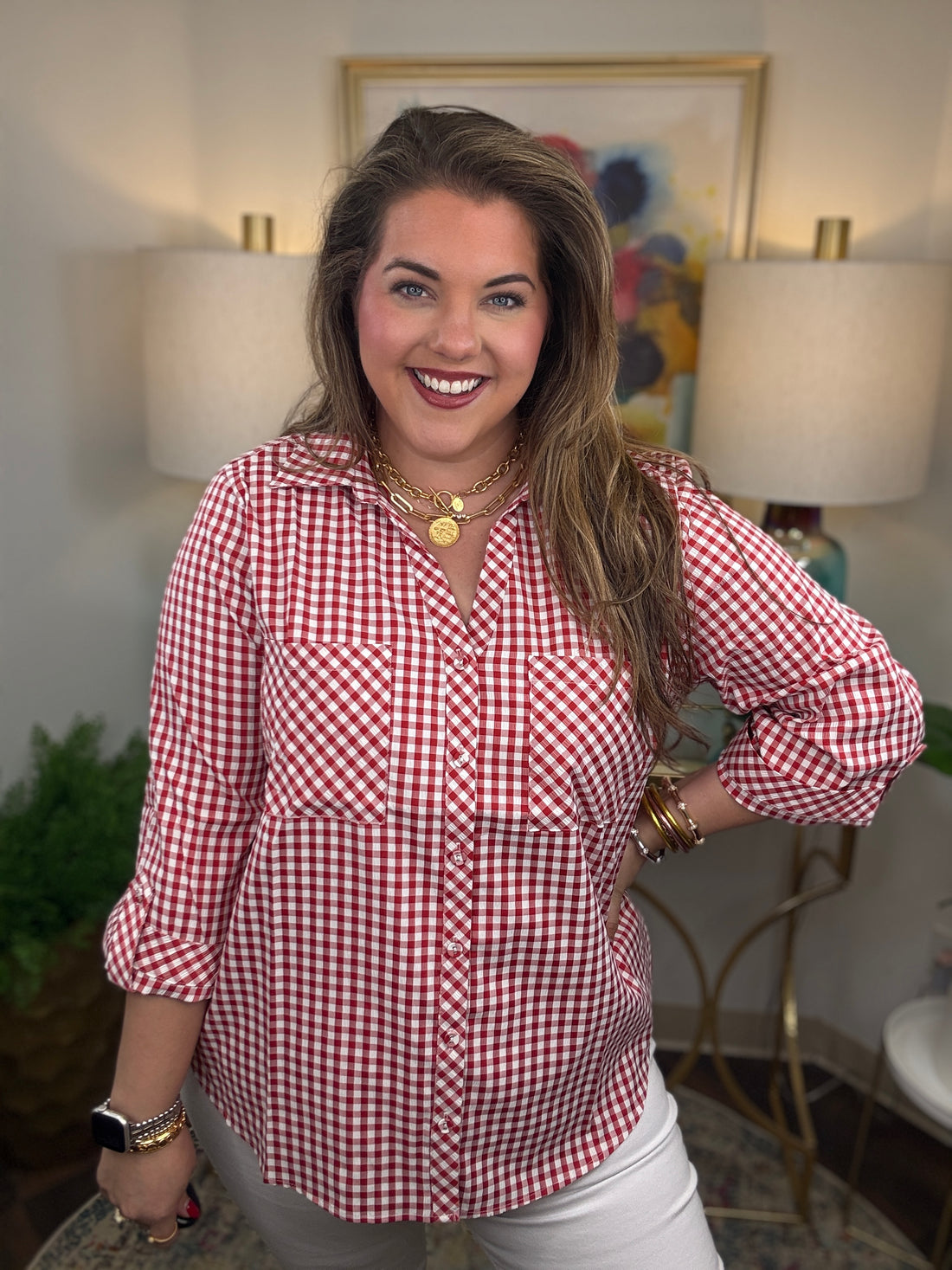 Woman wearing a red gingham button down top