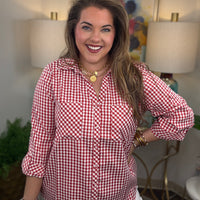 Woman wearing a red gingham button down top