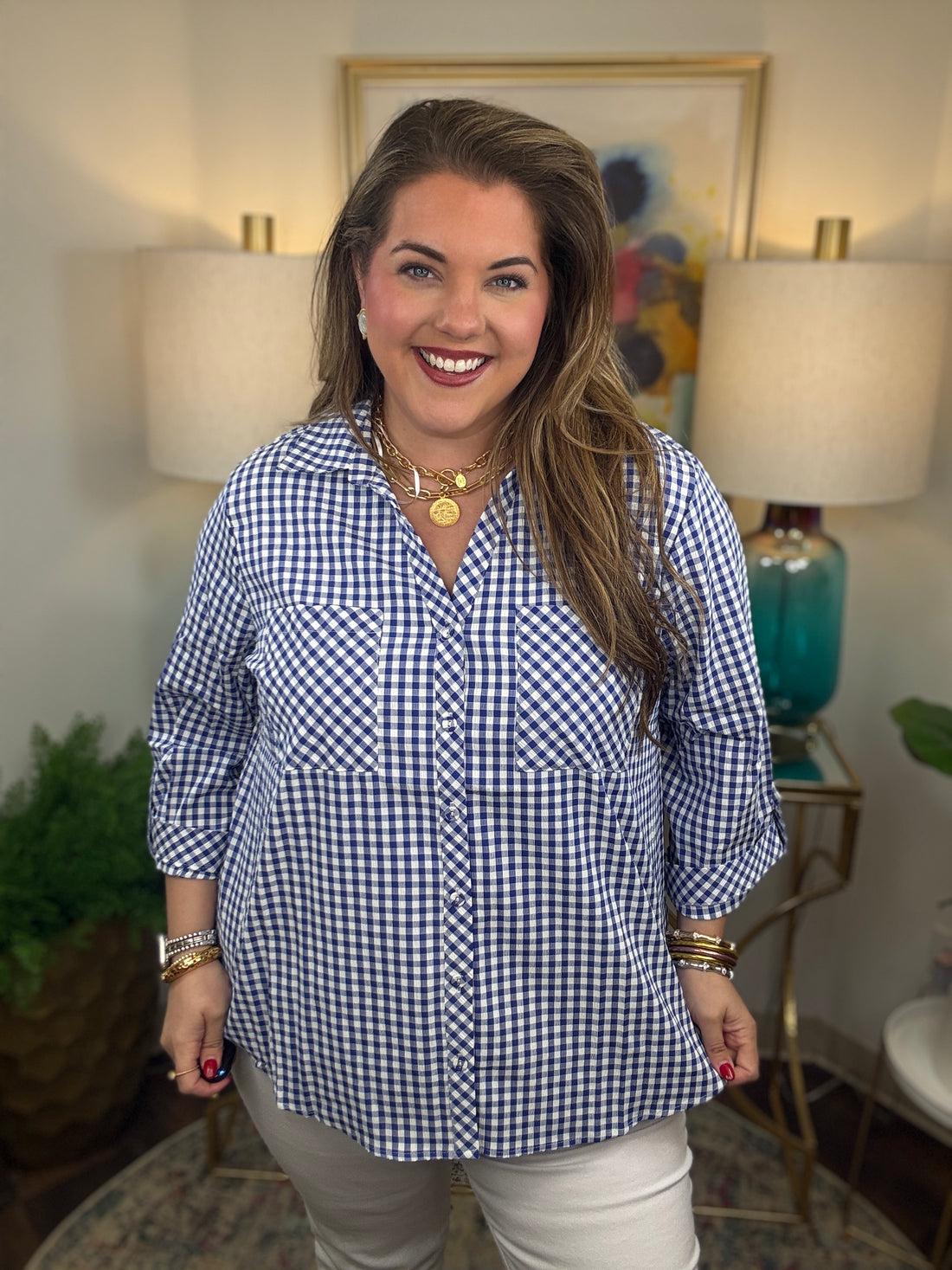 Woman wearing a royal blue gingham button down top