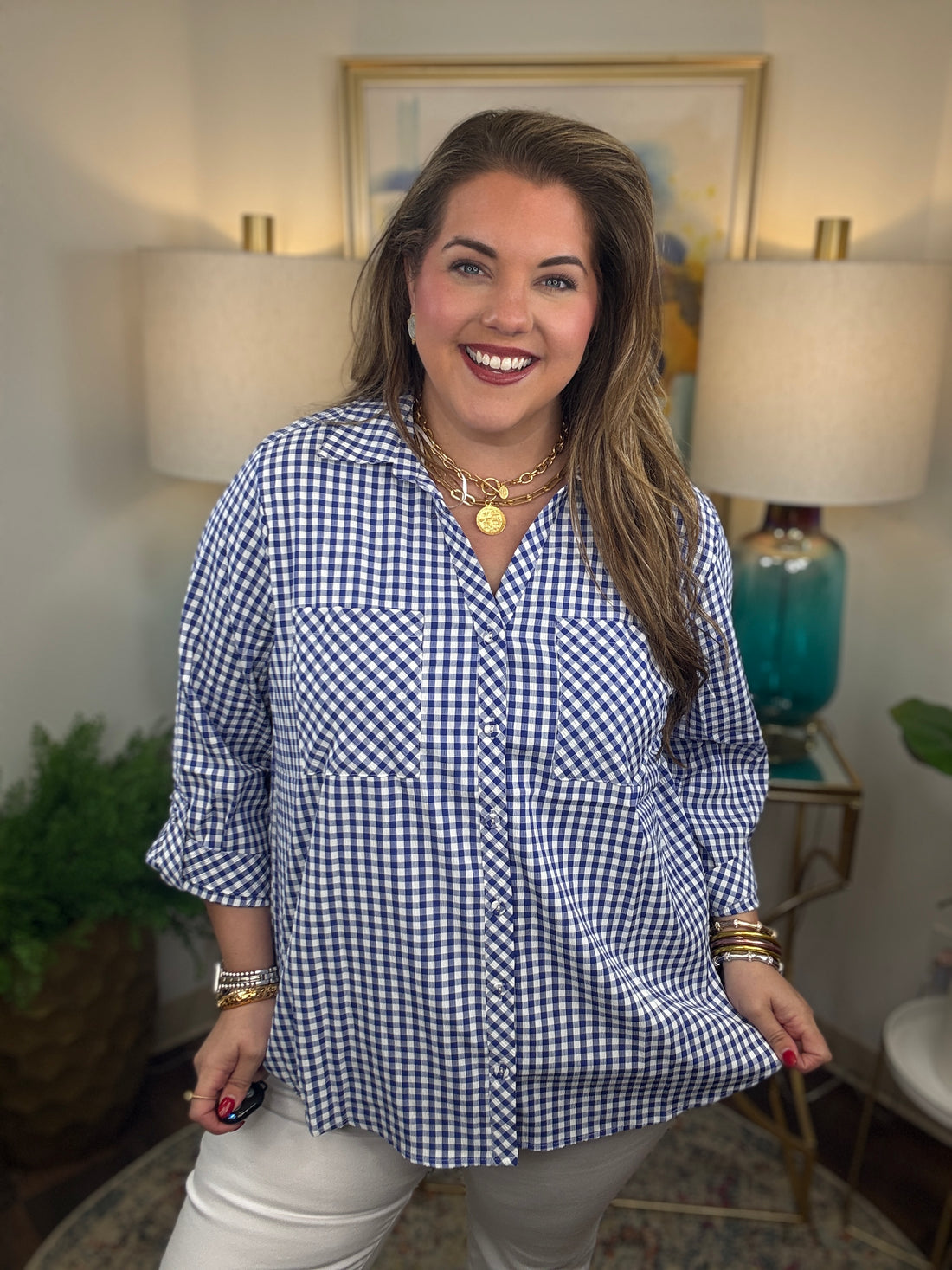 Woman wearing a royal blue gingham button down top