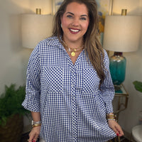Woman wearing a royal blue gingham button down top