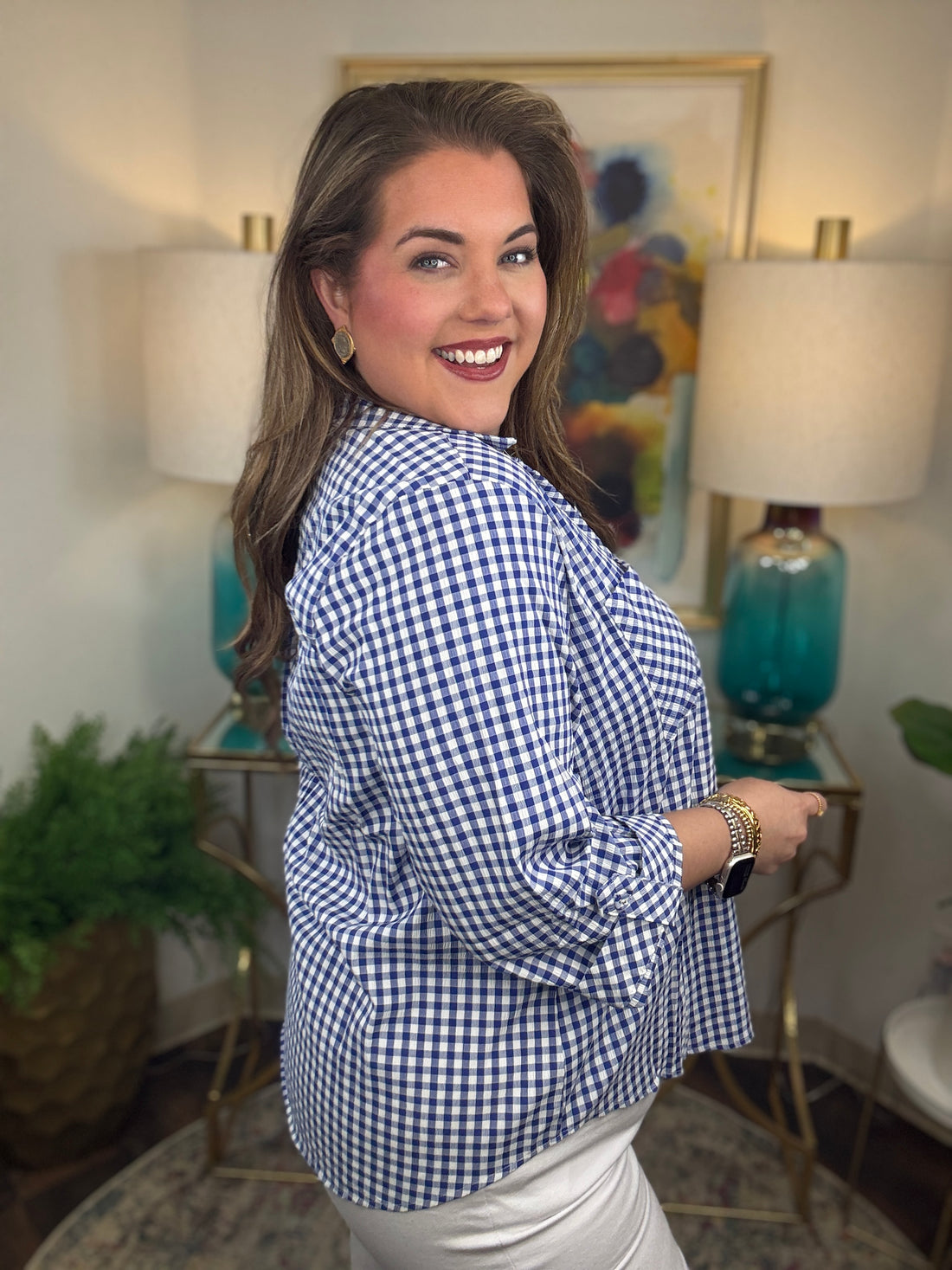 Woman wearing a royal blue gingham button down top