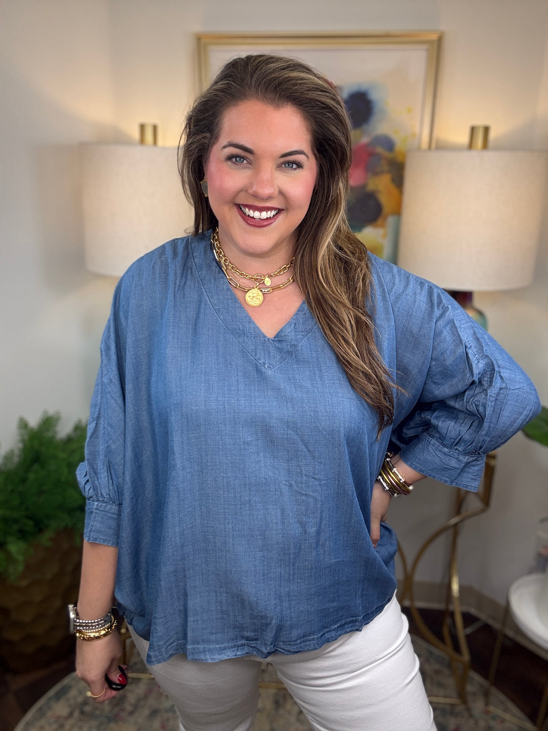 Woman wearing a denim v-neck dolman sleeve blouse