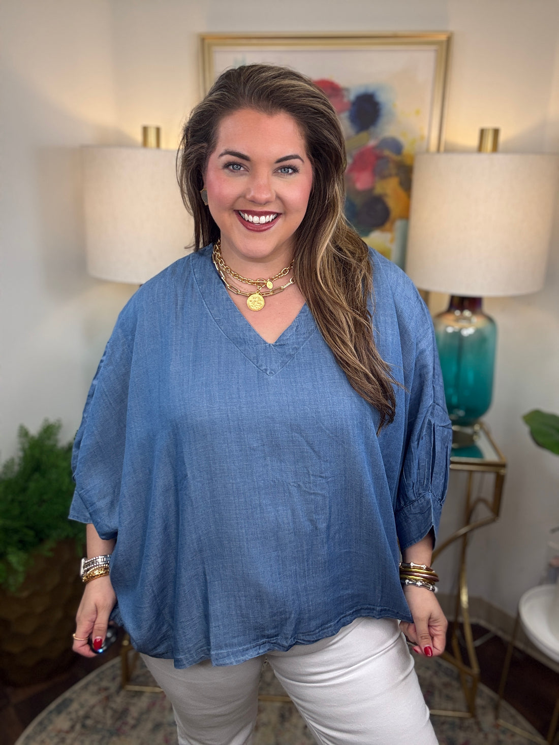 Woman wearing a denim v-neck dolman sleeve blouse