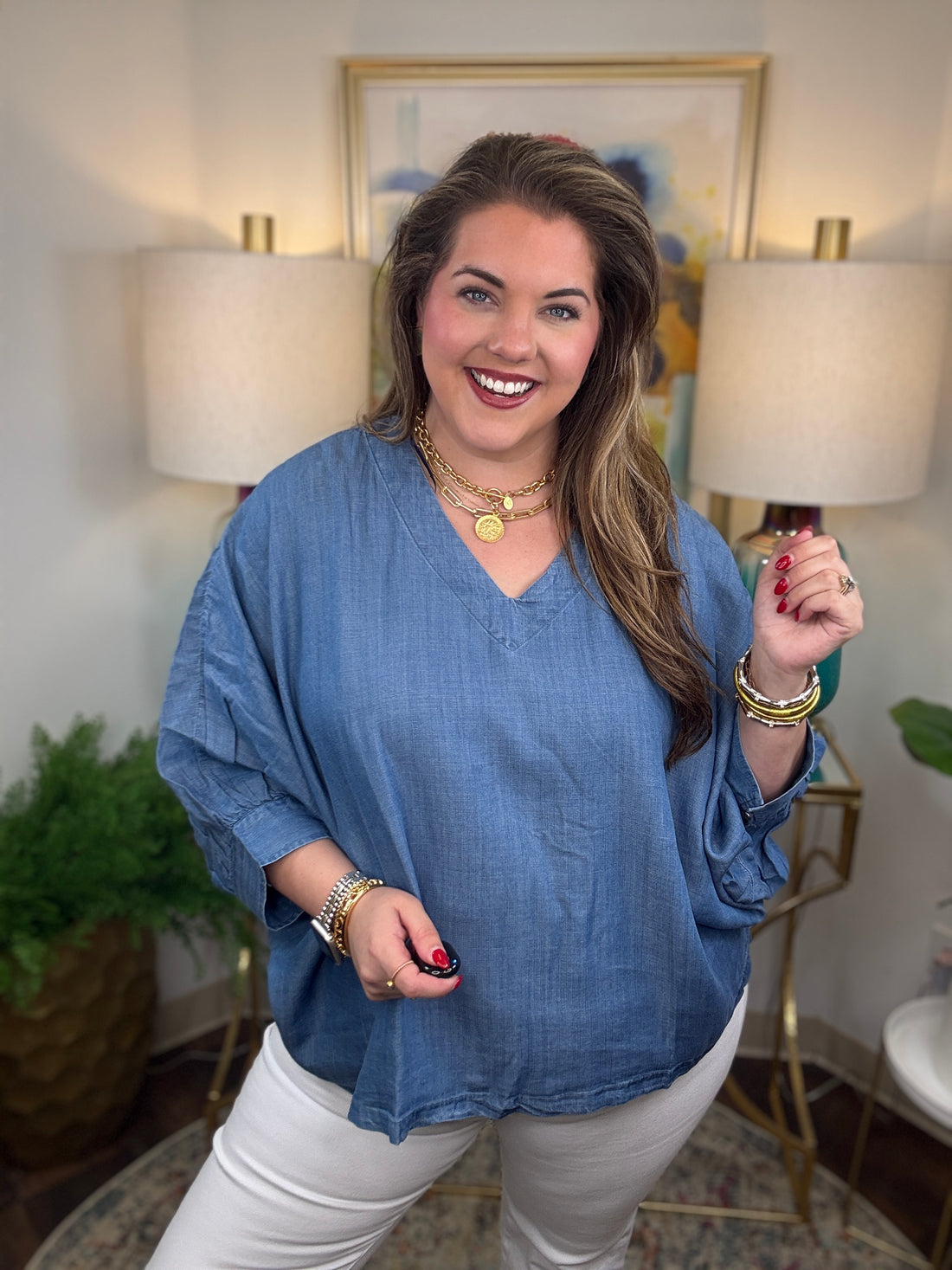 Woman wearing a denim v-neck dolman sleeve blouse