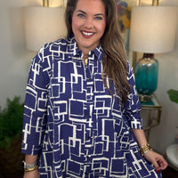Woman wearing a blue and white geometric patterned shirt