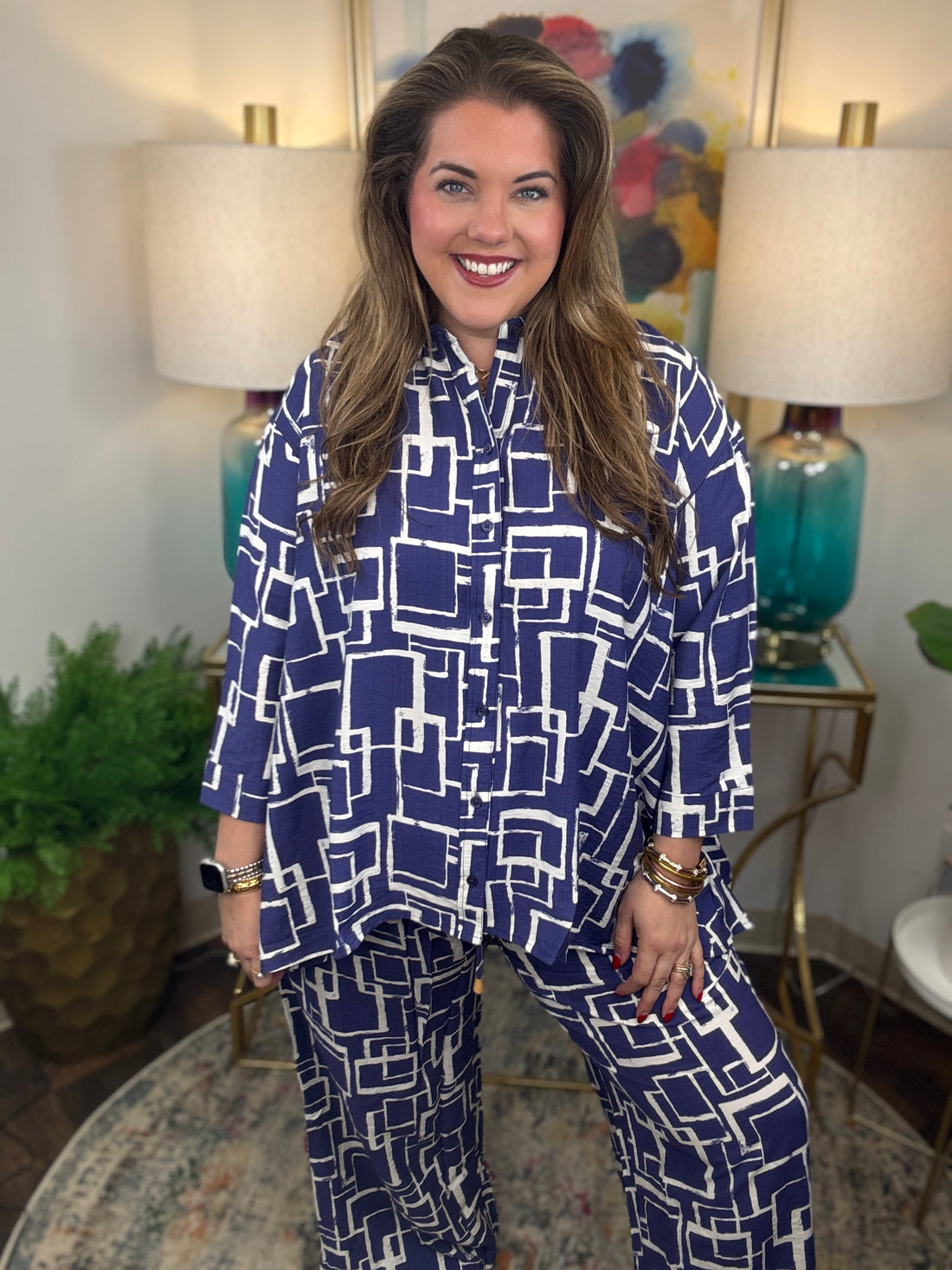 Woman wearing a blue and white geometric patterned shirt and pants