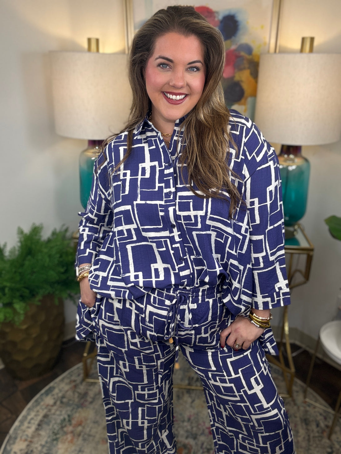 Woman wearing a blue and white geometric patterned shirt and pants