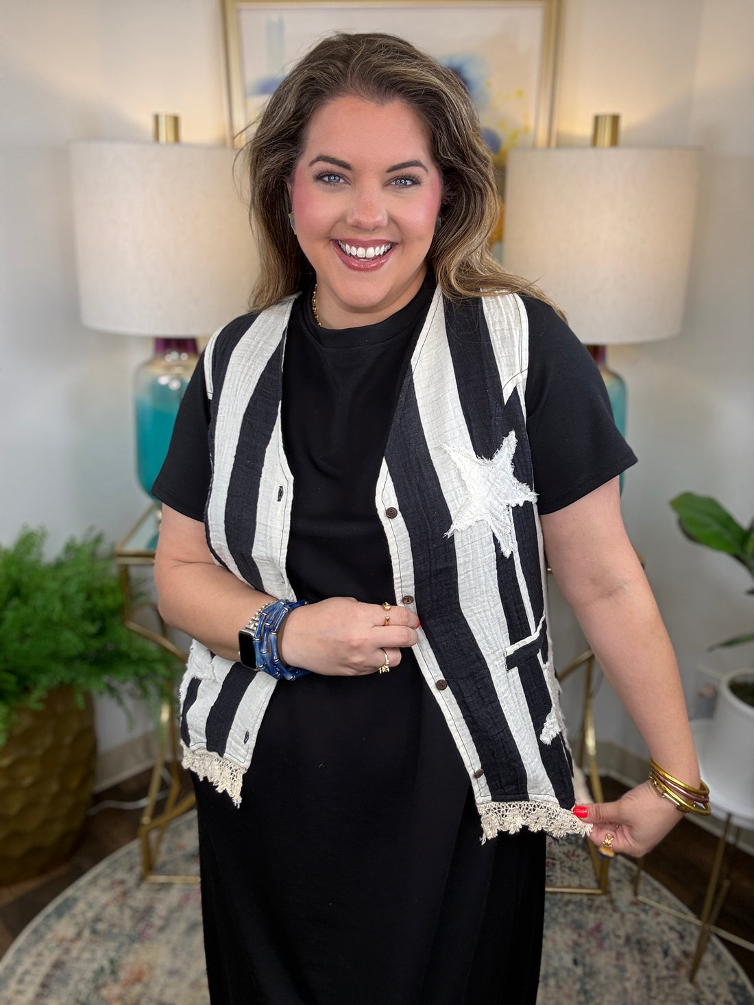 Woman wearing a cream and white striped vest with star appliques