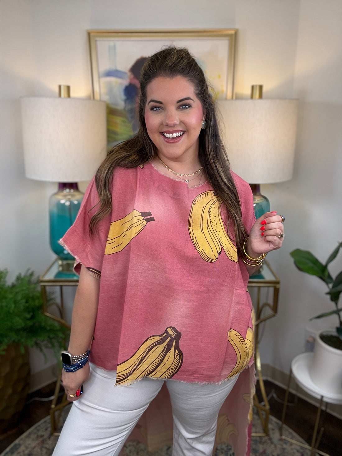 Woman wearing a pink short-sleeve top with a yellow banana print
