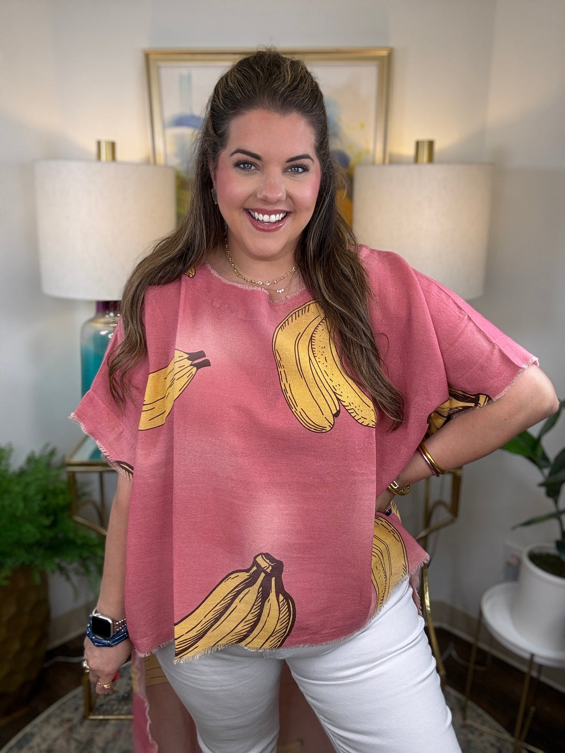 Woman wearing a pink short-sleeve top with a yellow banana print