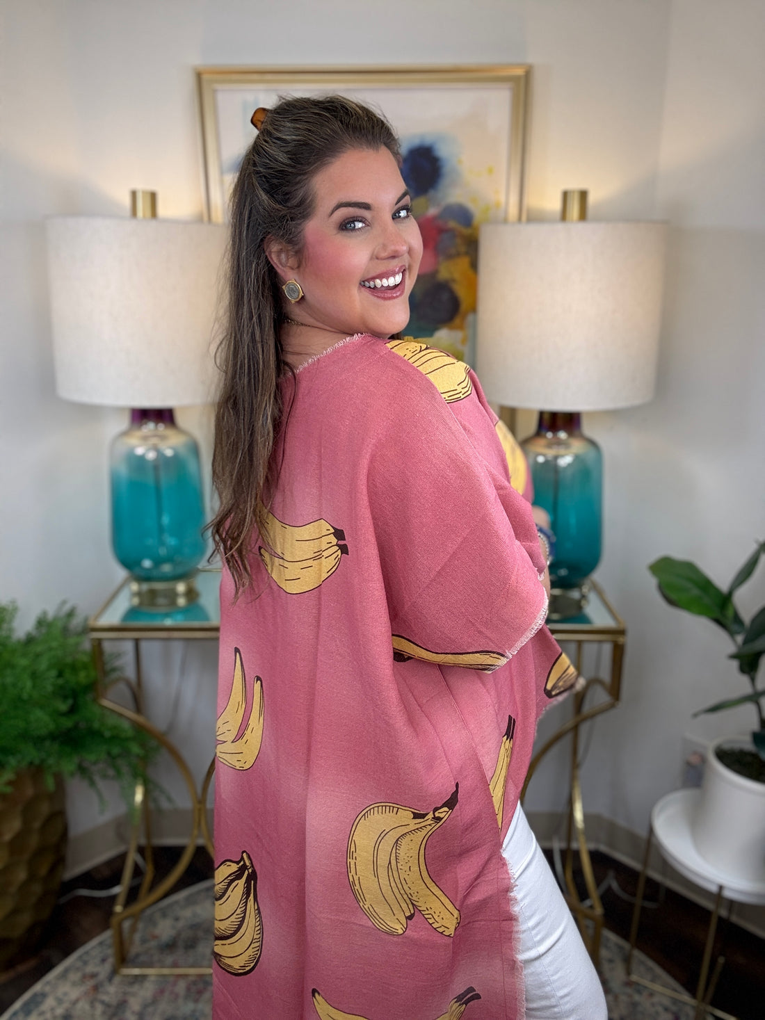 Woman wearing a pink short-sleeve top with a yellow banana print