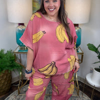 Woman in pink linen pants with a banana print all over