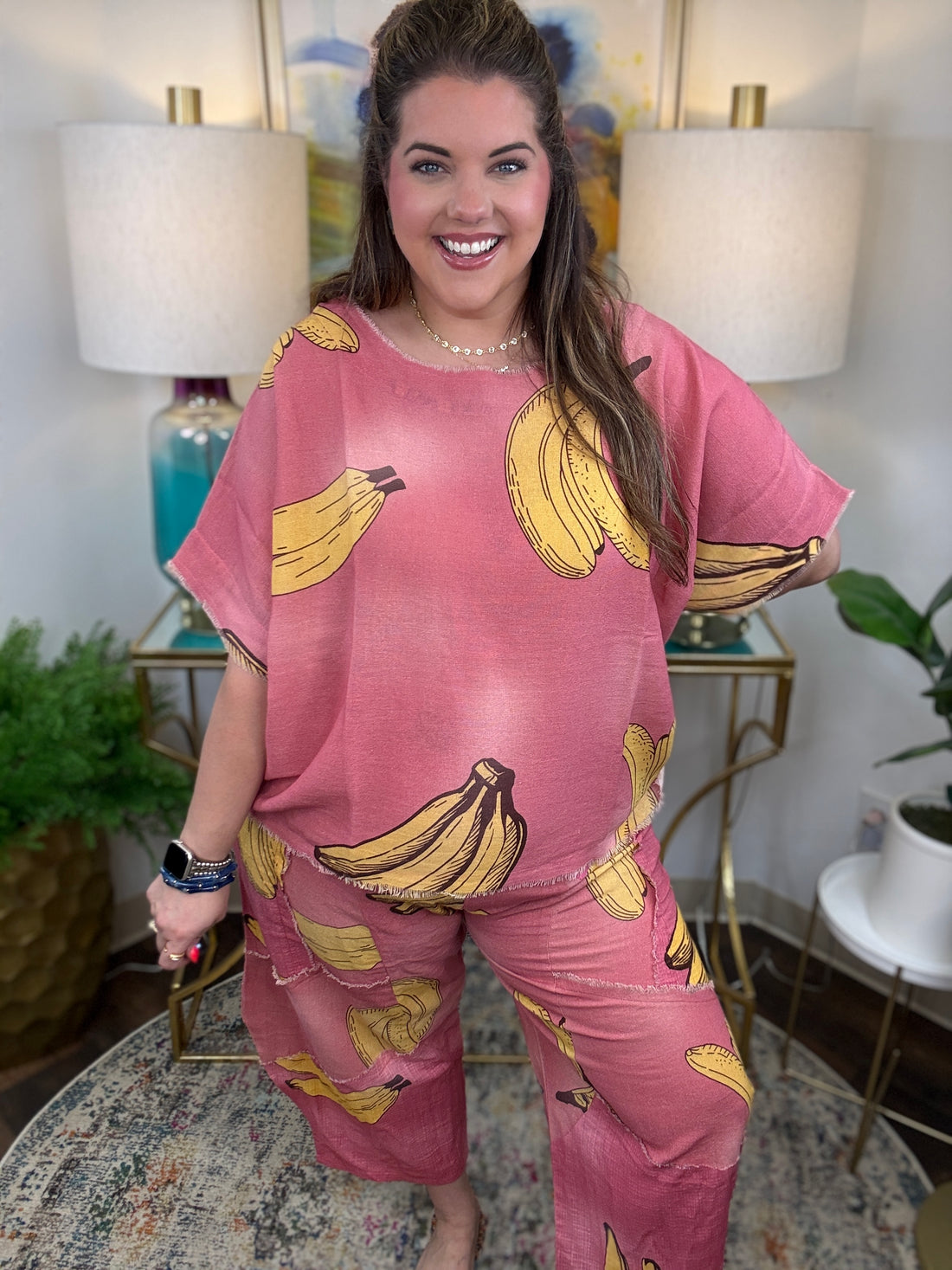 Woman in pink linen pants with a banana print all over