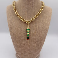 Colorful fish charm available in light blue, purple, green, navy, and gold