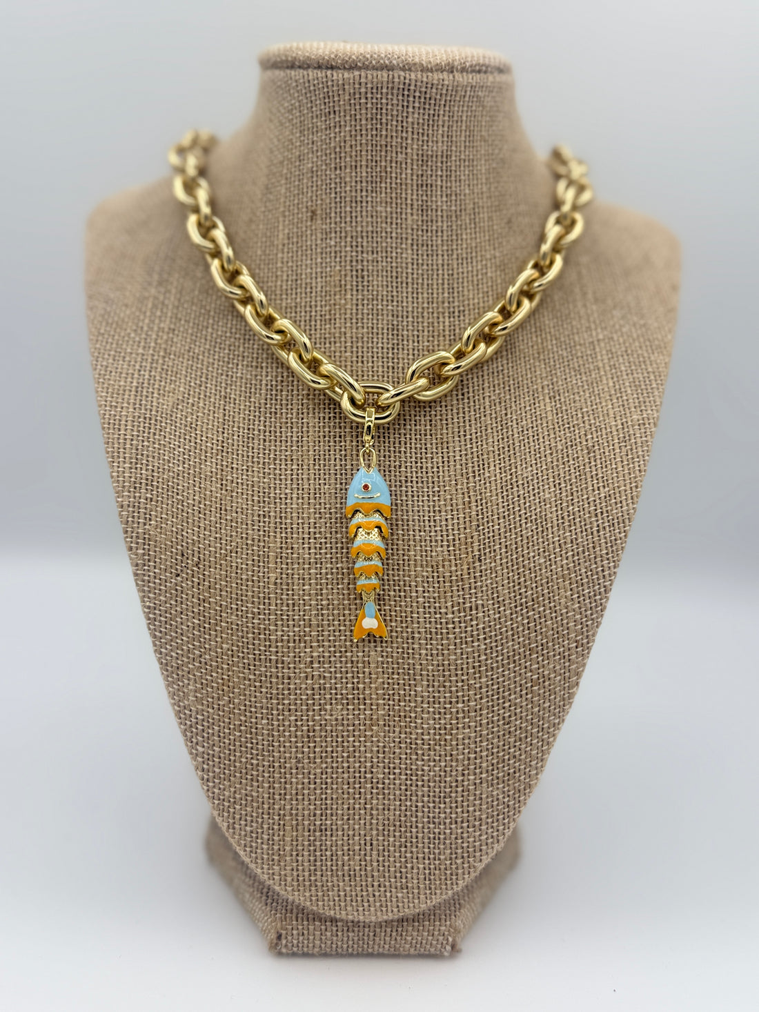 Colorful fish charm available in light blue, purple, green, navy, and gold
