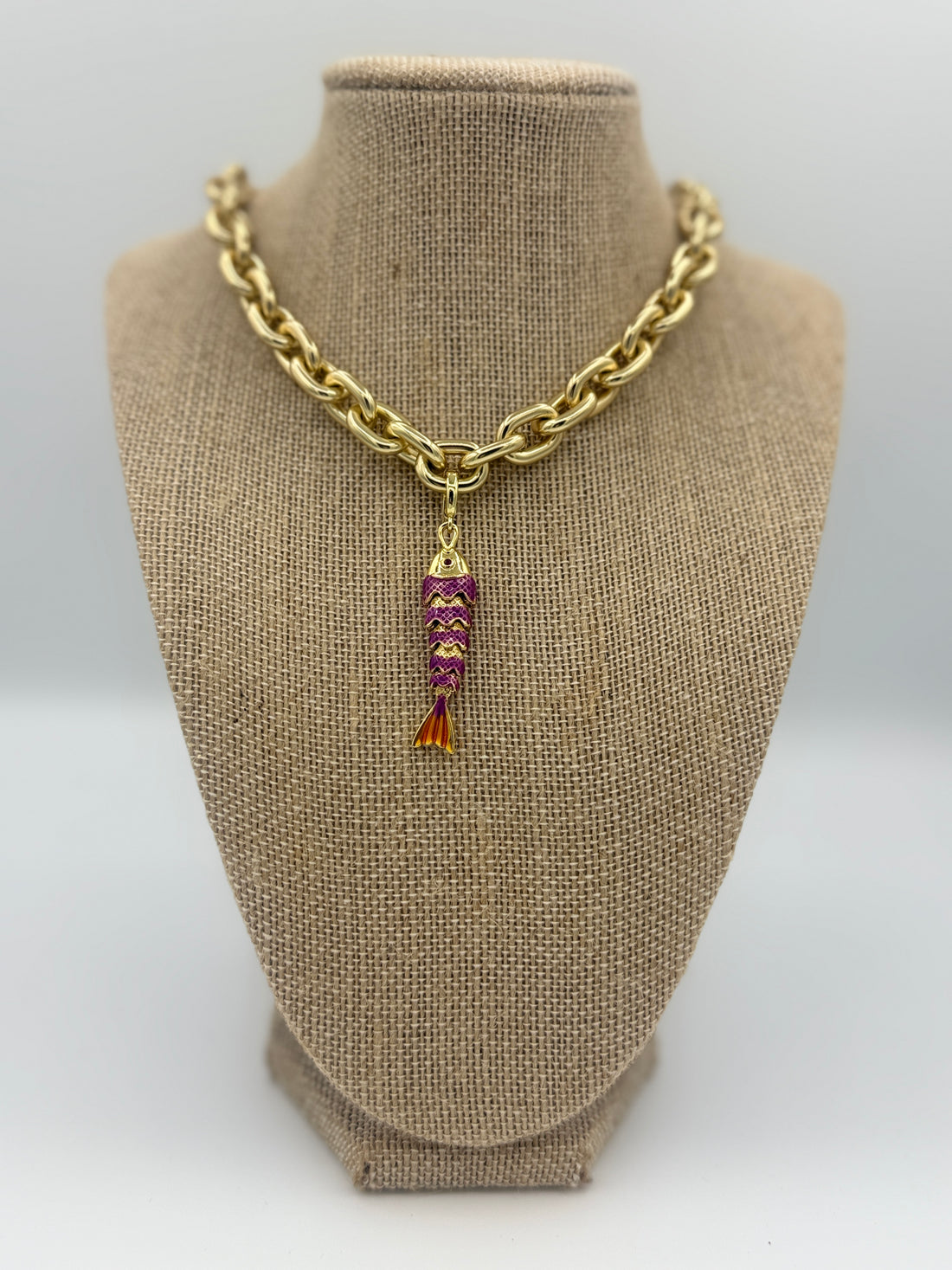 Colorful fish charm available in light blue, purple, green, navy, and gold