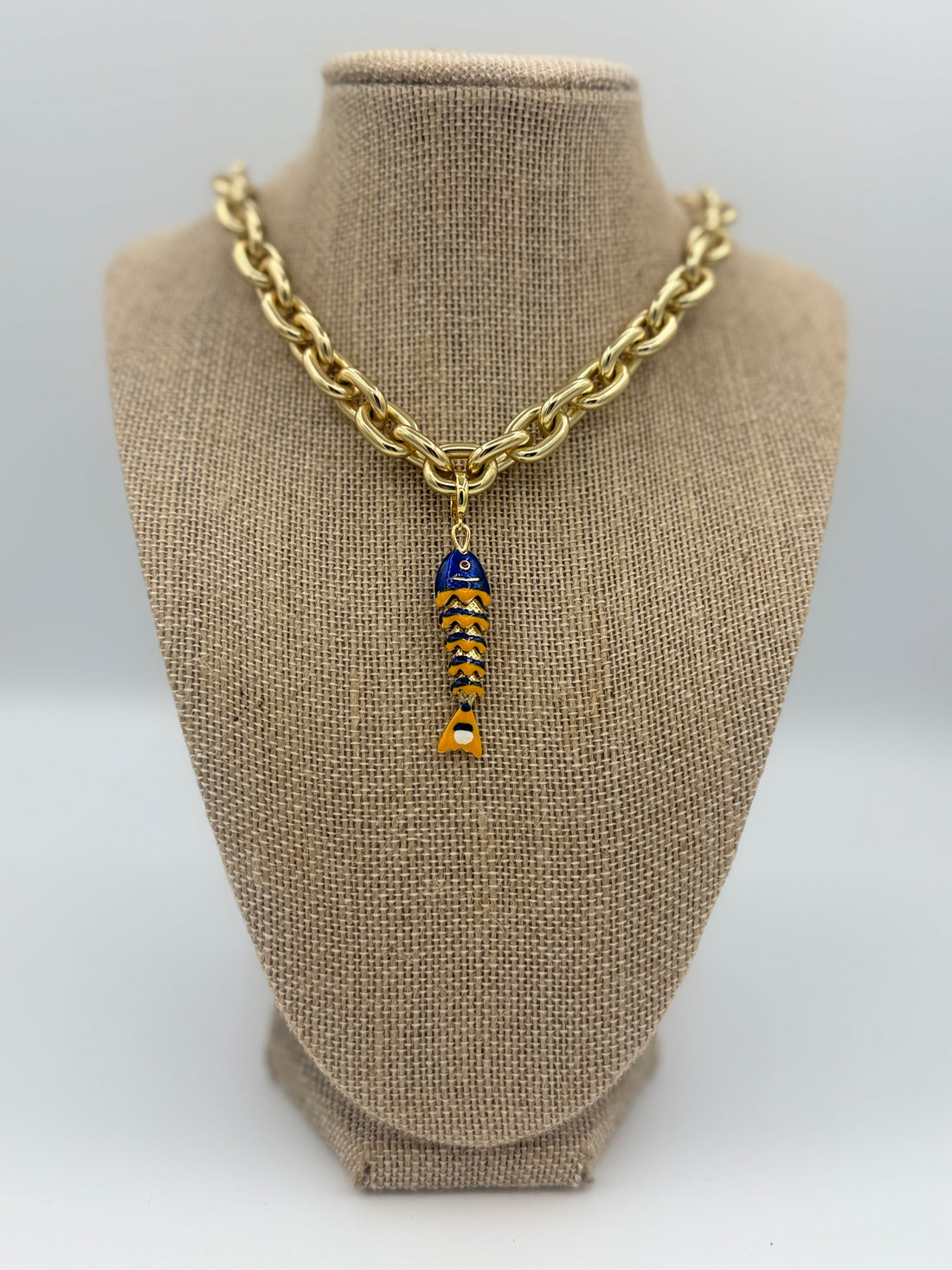 Colorful fish charm available in light blue, purple, green, navy, and gold