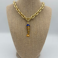 Colorful fish charm available in light blue, purple, green, navy, and gold