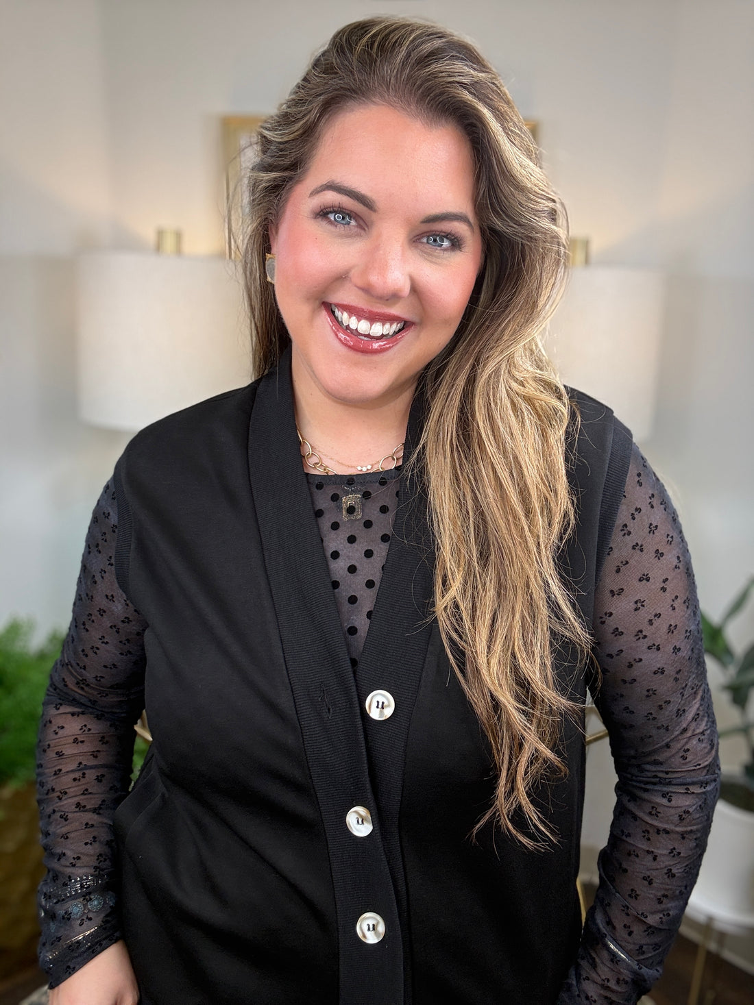 Black  mesh top with polka dot bodice and floral sleeve detail layering with black vest