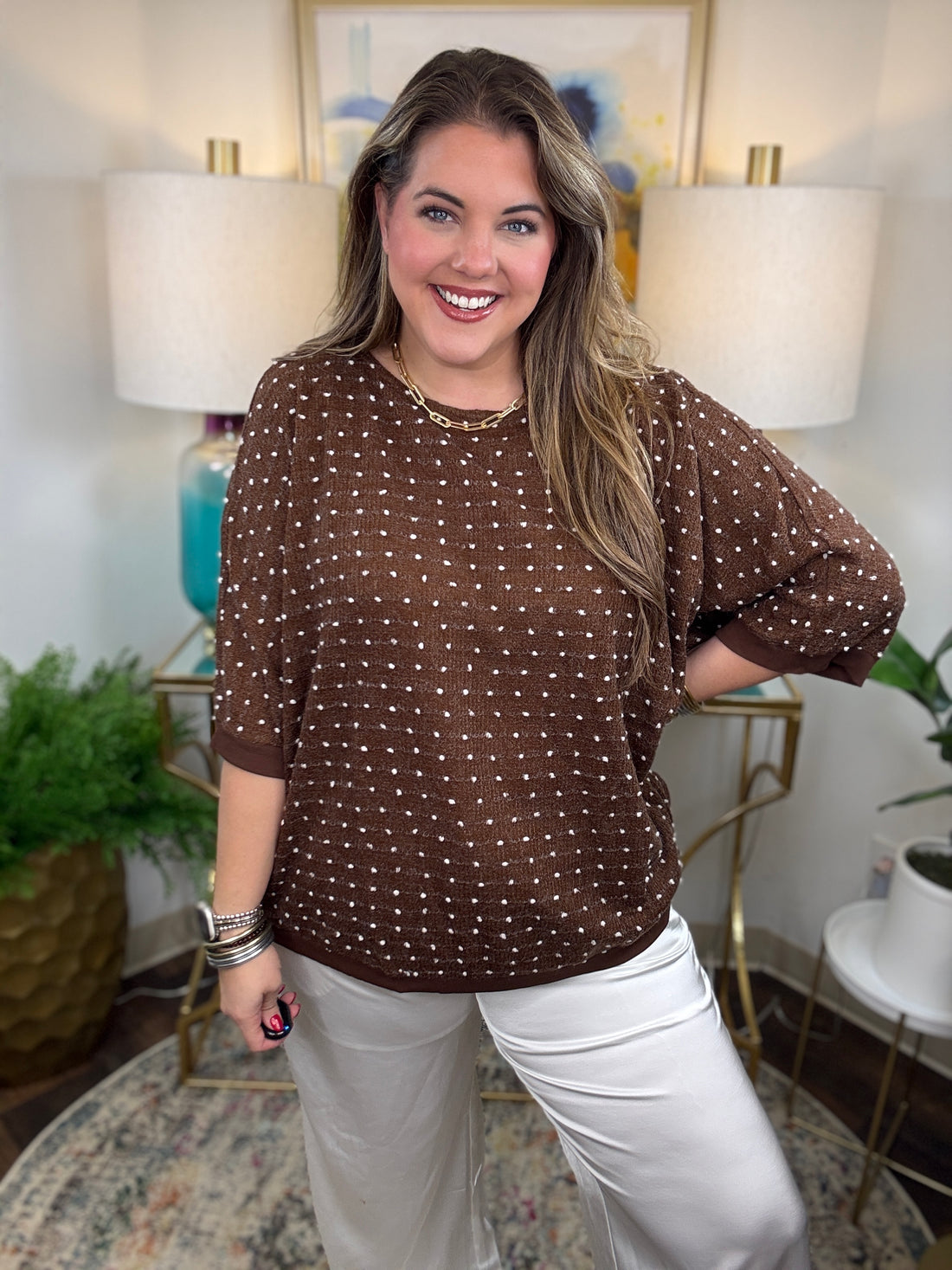 Brown curvy short-sleeve sweater with white polka dot stitching
