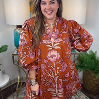 Rust floral dress with V-neck and 3/4-length balloon sleeves