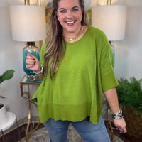 Women's oversized sweater with split side hem available in green or crimson
