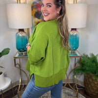 Women's oversized sweater with split side hem available in green or crimson