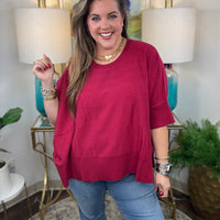 Women's oversized sweater with split side hem available in green or crimson